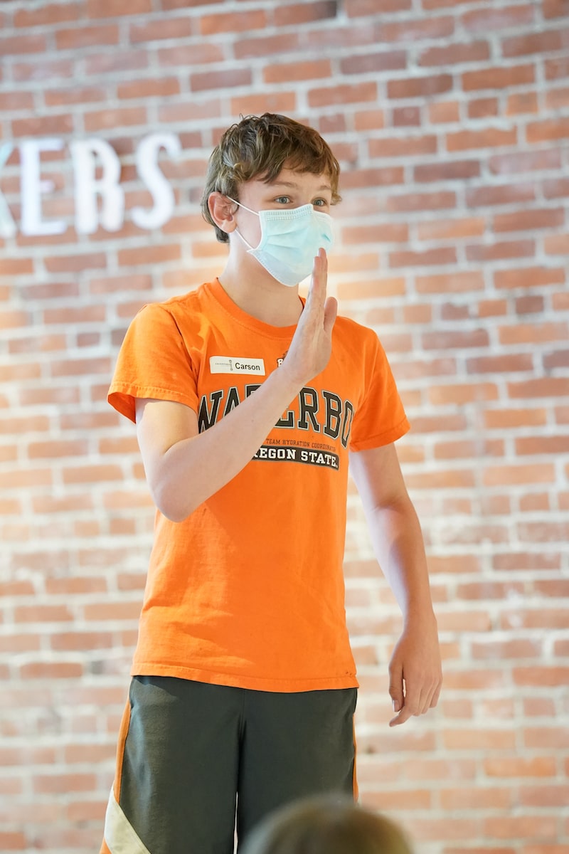 a boy with an orange shirt