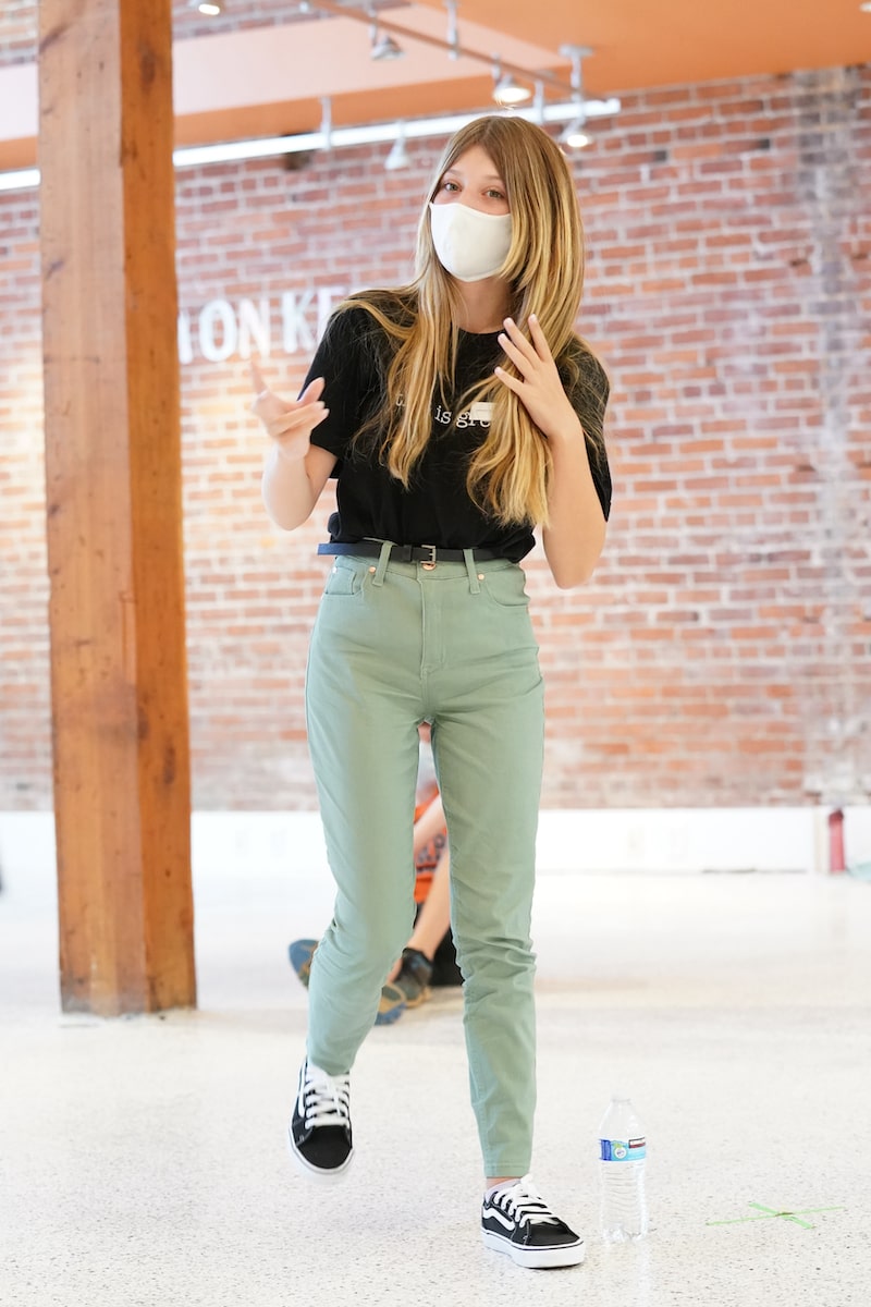 a girl with green pants performing