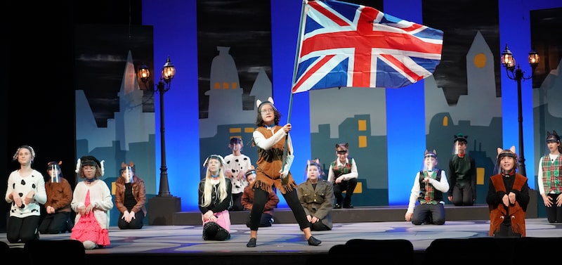 101 dalmations cast photo with british flag being flown above