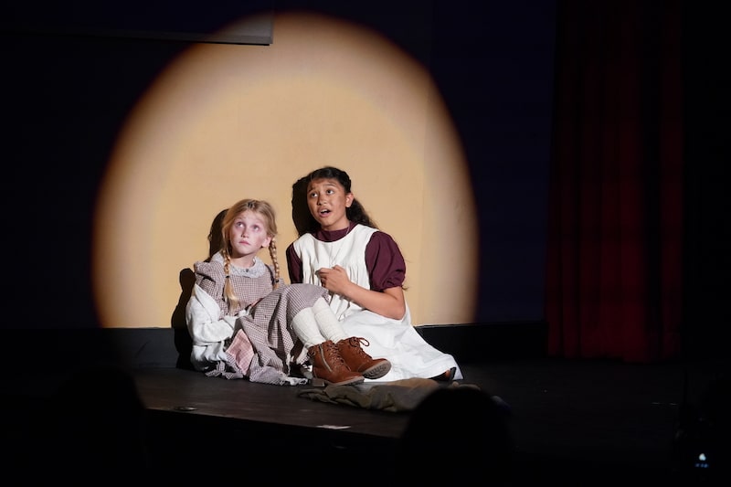 Annie and the youngest orphan singing
